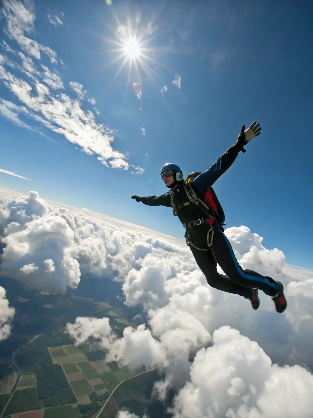 A smiling woman in a skydiving harness with an instructor, soaring through the blue sky with clouds in the background, representing the Tandem Skydiving Experience offered by All in Flight.